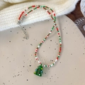 Detail of Christmas beaded necklace featuring red and green beads with a tree pendant - Christmas Tree