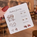 Close-up of 6-pair silver earring set with hearts and stars on daily display card - E1559-1 Red Gemstone Heart Series