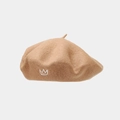Close-up of crown embroidery on a vintage camel wool beret with detailed texture - Khaki