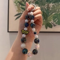 Chic acrylic beaded keychain with colorful laser beads and TOY tag held in hand - TOY Letter Multicolor