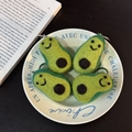 Handmade wool felt avocado keychains set with cute smiling faces in a decorative bowl - Avocado Trio