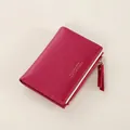 Close-up of a rose red short wallet with gold metal zipper and Forever Lucky lettering - Rose Red