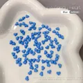 Macro shot of 4x5mm blue resin heart charms for nail art and DIY jewelry crafts - 100 Pieces Set / Blue