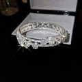 Detailed close-up of a silver multilayer flower bracelet with sparkling pavé crystals - Silver Flower Bangle