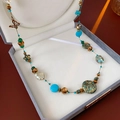 Détail d'un collier ethnique avec perles turquoise, bronze et pendentif papillon doré - Sautoir Perlé avec Pendentif Papillon Bohème (1# Collier - Bleu)