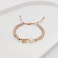 Detail of woven rope bracelet with natural white pearl and gold letter W charm - Letter W