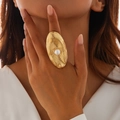 Chunky gold irregular textured ring with centered pearl inlay on model's hand - One Size (Adjustable Open) / Light Gold (0787 Oval Pleated Pearl)