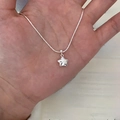 Handheld silver minimalist necklace featuring a solid star pendant on a delicate chain - Solid Pentagram Pendant Necklace (XL3198)