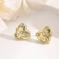 Macro detail of gold plated heart earrings with zircon inlay on a white ceramic plate - Multi-shape Zirconia Cluster-Gold