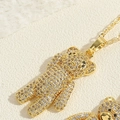 Macro shot of gold teddy bear pendant featuring micro-pave white zircons and black eyes - Full Zircon Bear