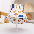 Close-up of kids sun hat with whale pattern, adjustable wind rope and soft fabric detail - Off-White Octopus