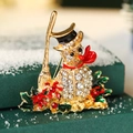 Christmas snowman brooch with sparkling crystals and red enamel on festive green gift box - Snowman