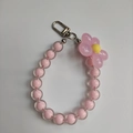 Close-up of pink floral beaded phone strap with transparent candy beads and silver clasp - Pink Beads Pink Flower