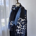 Winter scarf featuring dark blue leopard print and color-block design with fringe edges - Blue