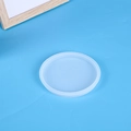 Translucent round silicone mold for resin coasters on a bright blue background - Round Coaster Mold