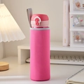 Pink fabric protective water bottle sleeve with grey handle strap on white desk - Rose Red