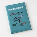 Detailed view of teal faux leather passport cover with white stitching and text - Lake Blue