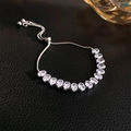 Detailed view of adjustable silver bracelet with oval white zircons on black leather - Silver