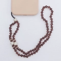 Detailed view of handmade beaded crystal phone lanyard with sparkling rhinestones - Deep purple