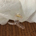 Elegant transparent acrylic hair claw clip with golden spring on textured background - Bright Transparent