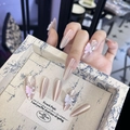 Macro shot of long pointed press-on nails with pearl cat-eye effect and 3D butterflies - By1618 Bee And Butterfly Love / Glue Type
