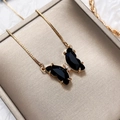 Detailed shot of a black crystal butterfly pendant with a golden box chain necklace - Black