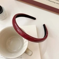 Minimalist deep wine red PU leather headband on a coffee cup in a lifestyle setting - Burgundy