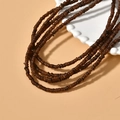Detailed view of 4mm dark brown irregular shell beads layered on a white tray - 10# Coffee 4mm (1 Strand)