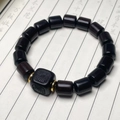Detail of sandalwood bead bracelet with engraved square bead and gold spacers - African Blackwood Smooth Sailing / 12mm / Dark Brown