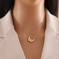 Golden letter W pendant necklace with elegant bead chain on model display - Letter W