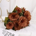 Artificial caramel carnation bouquet with green leaves on a white fabric background - Coffee