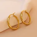 Close-up of 18K gold plated earrings with vintage dragon scale embossed textures - Gold 20mm