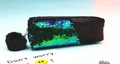 Macro detail of reversible mermaid sequins and soft black pompom on student pencil case - Green and Matte Black