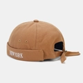 Detailed view of New York embroidery on a khaki canvas docker hat with adjustable strap - Caramel color