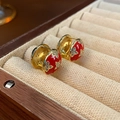 Golden earrings with red enamel finish and white clover crystal studs on a jewelry box - E4751 Ear Hook-Gold