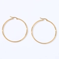 Close-up of oversized polished gold geometric round hoop earrings with minimalist style - Round (Gold)