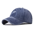 Close-up of heart embroidery and vintage washed denim texture on blue baseball cap - Adjustable / Navy Blue