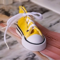 Mini high-top canvas sneaker keychain in bright yellow with white laces and rubber sole - Yellow
