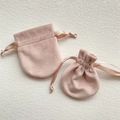 Pink velvet drawstring jewelry pouches in two sizes shown on beige textured background - 7x8.5cm / Pink