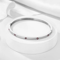 Polished silver stainless steel bangle with pink zircons on elegant white display - 4mm / Silver-Pink Zirconia