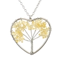 Detail of handmade wire-wrapped heart pendant with yellow crystal tree of life design - Citrine