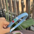 Light blue fabric headband featuring three colorful buttons and sweet bow design - Haze Blue Narrow Headband with Multi-Color Buttons