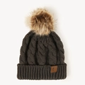 Close-up of brown cable knit beanie with faux fur pompom and letter E leather patch - One Size / Dark Gray