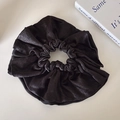Elegant large black scrunchie with pleated pearlescent fabric texture in minimalist style - Black