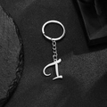 Polished stainless steel keychain featuring a silver letter d pendant on black background - Letter I
