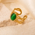 Detailed view of an open golden ring with a green oval gemstone and woven texture - Braided Green Cat's Eye Adjustable Style (TYR0716)