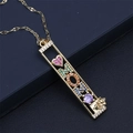 Detail of MOM pendant necklace with rainbow zircon inlay on gold wave chain - MOM