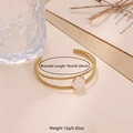 Detail view of gold twisted cable cuff bracelet with white stone measuring 16cm in length - White Stone Style (B02300G-2)