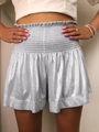 Detailed view of silver metallic fabric texture and high-waisted elastic waistband on shorts - Metallic Silver