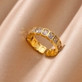 Macro view of gold adjustable ring with rectangular zircons on champagne silk background - Baguette White Row Zirconia Style (JZ6068G-3)